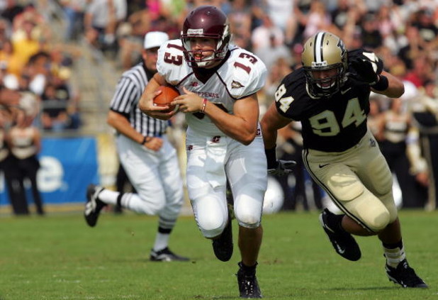 WEST LAFAYETTE, IN - SEPTEMBER 20:  Quarterback Dan LeFevour #13 of the Central Michigan Chippewas runs the ball past Ryan Kerrigan #94 of the Purdue Boilermakers at Ross-Ade Stadium on September 20, 2008 in West Lafayette, Indiana.  (Photo by Ronald Mart