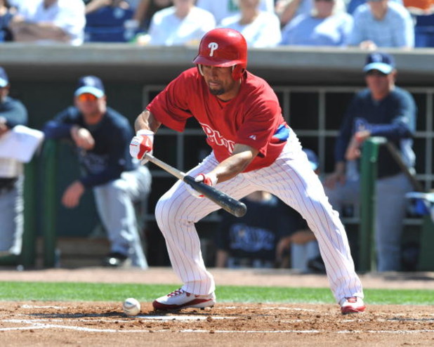 CLEARWATER, FL - FEBRUARY 28:  Outfielder Shane Victorino #8 of the  Philadelphia Phillies bunts against the Tampa Bay Rays February 28, 2009 at Bright House Field in Clearwater, Florida.  (Photo by Al Messerschmidt/Getty Images)