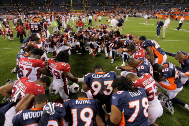 DENVER - SEPTEMBER 03:  Players from the Arizona Cardinals and the Denver Broncos meet at midfiled for a group prayer after the game during NFL preseason action at Invesco Field at Mile High on September 3, 2009 in Denver, Colorado. The Broncos defeated t