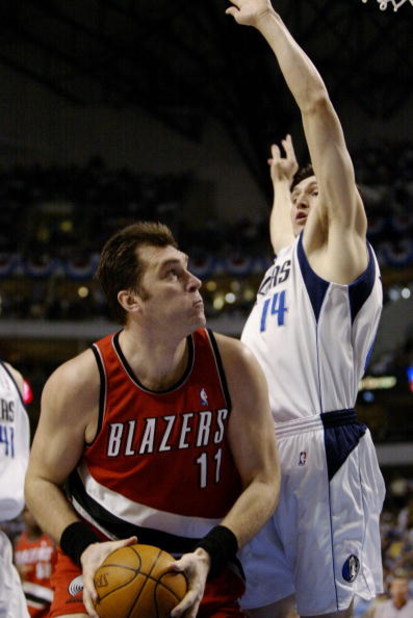 DALLAS - MAY 4:  Arvydas Sabonis #11 of the Portland Trail Blazers attempts to go to the basket while being guarded by Eduardo Najera #14 of the Dallas Mavericks in Game seven of the Western Conference Quarterfinals during the 2003 NBA Playoffs at America