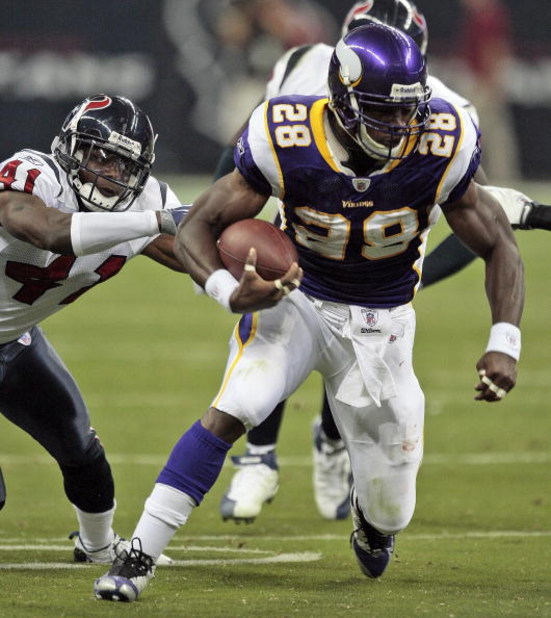 HOUSTON - AUGUST 31:  Running back Adrian Peterson #28 of the Minnesota Vikings breaks a tackle by cornerback Brice McCain #41 of the Houston Texans at Reliant Stadium on August 31, 2009 in Houston, Texas.  (Photo by Bob Levey/Getty Images)