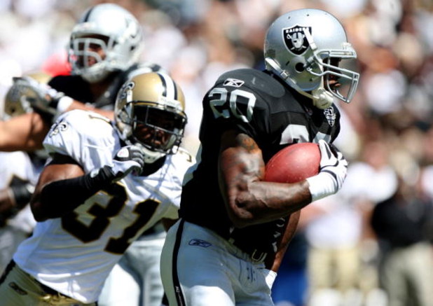 OAKLAND, CA - AUGUST 29:  Running back Darren McFadden #20 of the Oakland Raiders runs the ball against Pierson Prioleau #31 of the New Orleans Saints during the preseason game at Oakland-Alameda County Coliseum on August 29, 2009 in Oakland, California. 
