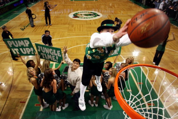 BOSTON - MAY 28:  The Boston Celtics mascot, 'Lucky' dunks the ball after receiving it from Tedy Bruschi of the New England Patriots during a break in play against the Detroit Pistons during Game Five of the Eastern Conference finals during the 2008 NBA P