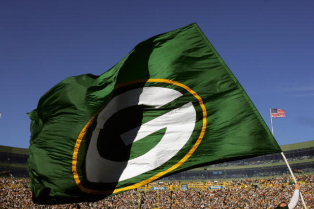 GREEN BAY, WI - OCTOBER 29: A Green Bay Packers flag is waved during a game against the Arizona Cardinals at Lambeau Field on October 29, 2006 in Green Bay Wisconsin. The Packers won 31-14. (Photo by Stephen Dunn/Getty Images)