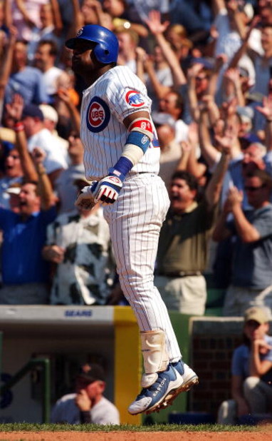 CHICAGO - JULY 1:  Sammy Sosa #21 of the Chicago Cubs does his trade-mark hop as fans cheer after hitting a walk-off home run in the tenth inning to beat the Houston Astros during a game on July 1, 2004 at Wrigley Field in Chicago, Illinois. The Cubs defe