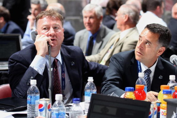 MONTREAL, QC - JUNE 27:  (L-R) General Manager Mike Gillis and assistant General Manager Laurence Gilman of the Vancouver Canucks sit at the draft table during the 2009 NHL Entry Draft at the Bell Centre on June 27, 2009 in Montreal, Quebec, Canada. (Phot