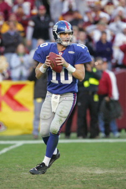 LANDOVER, MD - DECEMBER 24:  Quarterback Eli Manning #10 of the New York Giants drops back to pass against the Washington Redskins at FedExField on December 24, 2005 in Landover, Maryland. The Redskins defeated the Giants 35-10. (Photo by Jim McIsaac/Gett