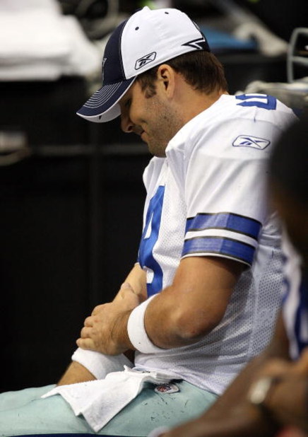 IRVING, TX - DECEMBER 14:  Quarterback Tony Romo #9 of the Dallas Cowboys grabs his right arm on the sidelines during play against the New York Giants at Texas Stadium on December 14, 2008 in Irving, Texas.  (Photo by Ronald Martinez/Getty Images)